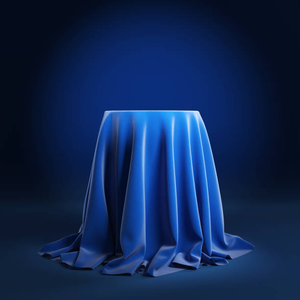 istock Round podium covered with blue cloth on a blue background. 1220792932