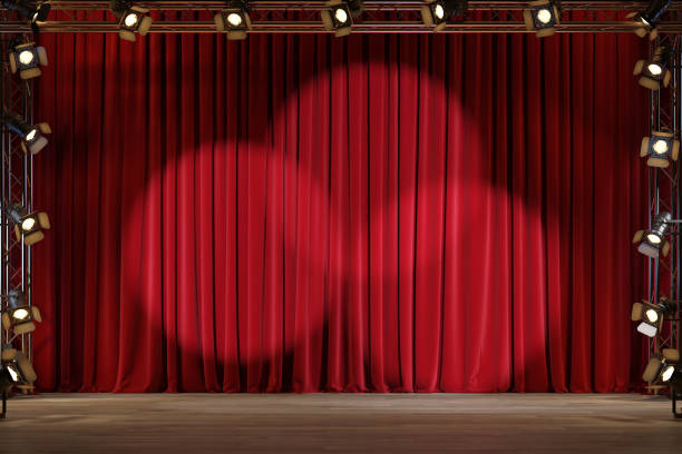 istock Empty theater stage with red velvet curtains and spotlights. 1220793494