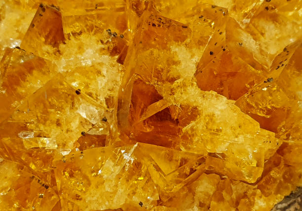Crystals of orange optical calcite with clear geometric edges and luminous veins. These rocks of stones, upon closer examination, turned into a separate universe in my imagination. And we can only be surprised and admired by this incredible beauty that nature and God himself created. calcite stock pictures, royalty-free photos & images