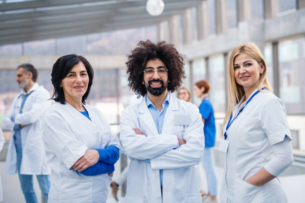 istock Group of doctors standing in corridor on medical conference. 1220794784