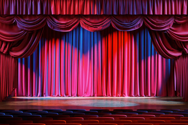 istock Empty theater stage with red velvet curtains. 1220794833