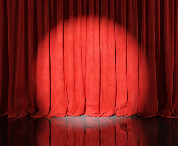 istock Red velvet stage curtains with flash or spotlight. 1220794928