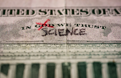 word God crossed out and replaced by science on a US dollar bill