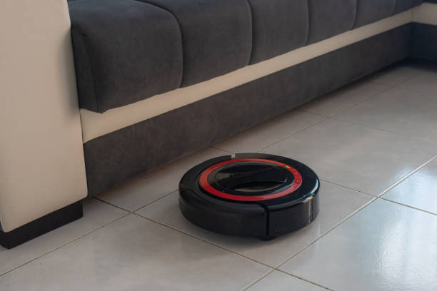 istock Robot vacuum cleaner automatically cleaning the floor. 1220797299