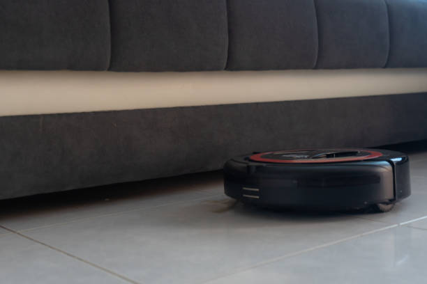 istock Robot vacuum cleaner automatically cleaning the floor. 1220797337