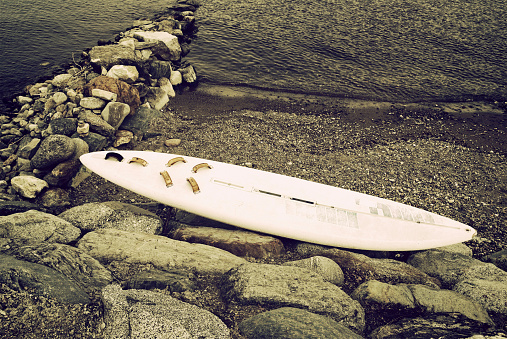 retro styled photo of a wrecked surfboard