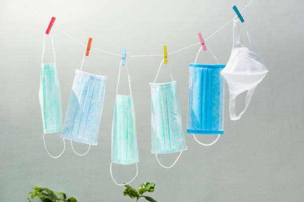 surgical mask on washing line for spread protection anti bacteria and Corona virus Disease (COVID-19) stock photo