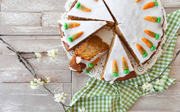 Carrot cake with frosting Homemade carrot cake with frosting and candy carrots carrot cake stock pictures, royalty-free photos & images