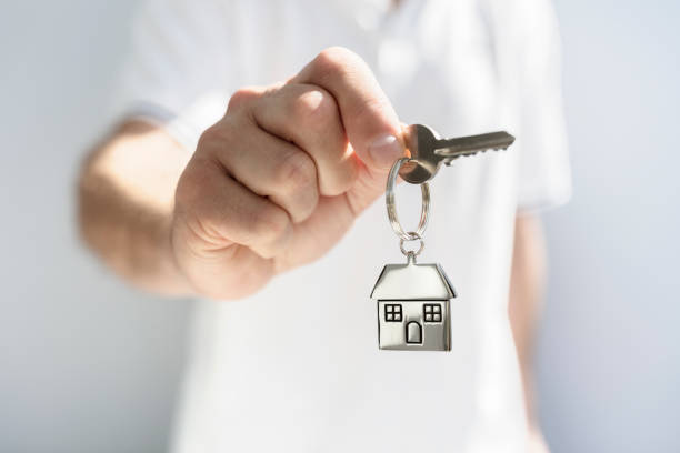 real estate agent giving house keys - key real estate key ring house key imagens e fotografias de stock