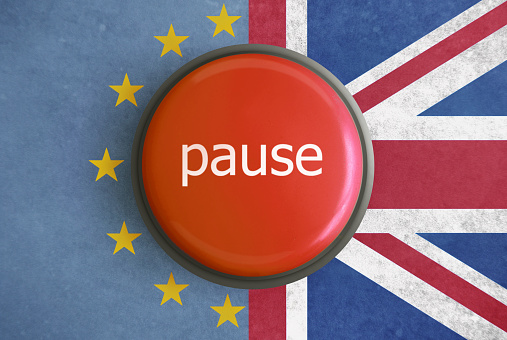 Brexit pause play button against eu and uk flag background