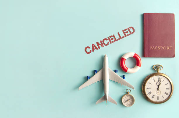 Travel cancellations Cancelled stamped by travel assessories including miniature airplane, clock and passport with space travel refund stock pictures, royalty-free photos & images