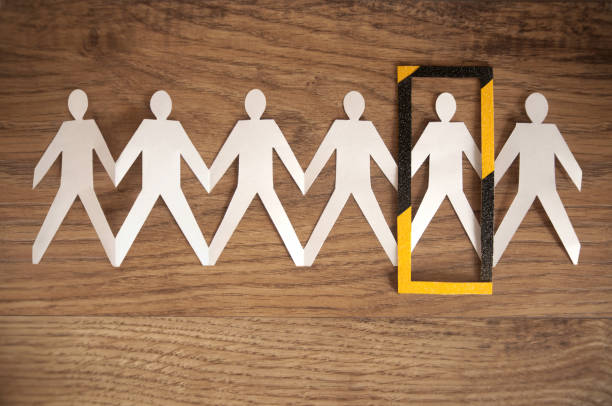 istock Self isolation social distancing human paper chain 1220802800