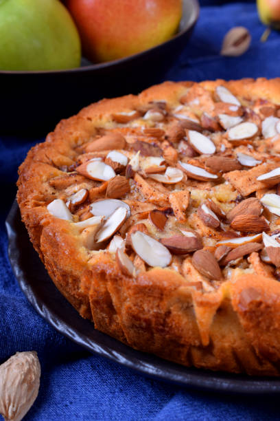 istock Pie with pears, apples and almonds on a black ceramic plate 1220806609