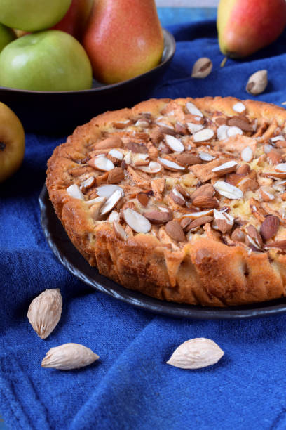 istock Pie with pears, apples and almonds on a black ceramic plate 1220806637