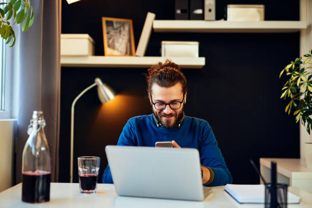 istock Attractive Caucasian bearded entrepreneur sitting in his home office, taking a break from work. Work from home concept. 1220807720