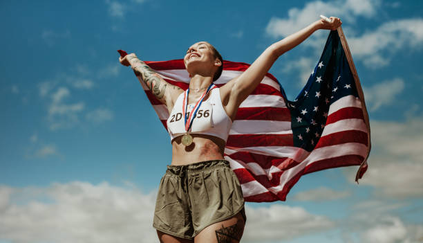 istock Athlete enjoying victory with US national flag 1220807934