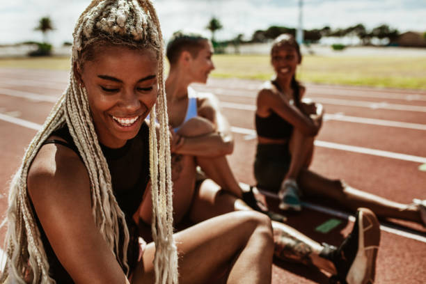 istock Sportswoman relaxing and stretching after a practice run on the track 1220809114
