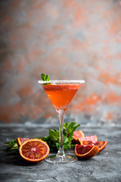 istock Red cocktail with bloody oranges in martini glass on the rustic background 1220809329