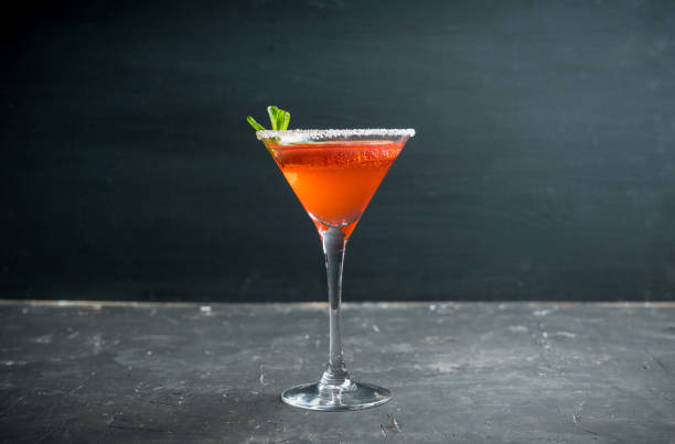 istock Red cocktail with bloody oranges in martini glass on the rustic background 1220809332