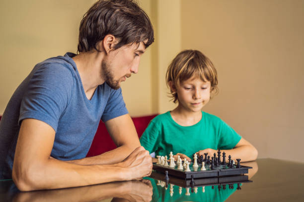 istock Happy Family Playing Board Game At Home 1220810614