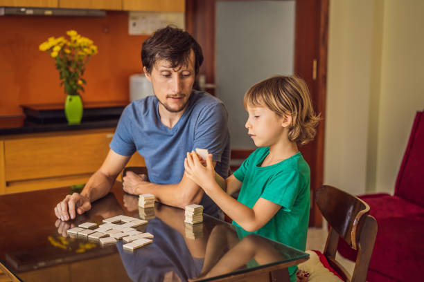 istock Happy Family Playing Board Game At Home 1220810671