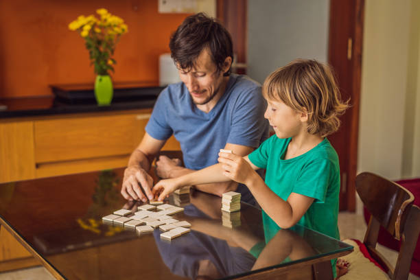istock Happy Family Playing Board Game At Home 1220810673