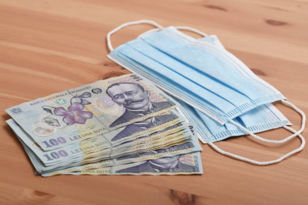 istock Face mask and 100 lei banknotes - trading concept during corona virus outbreak 1220810674