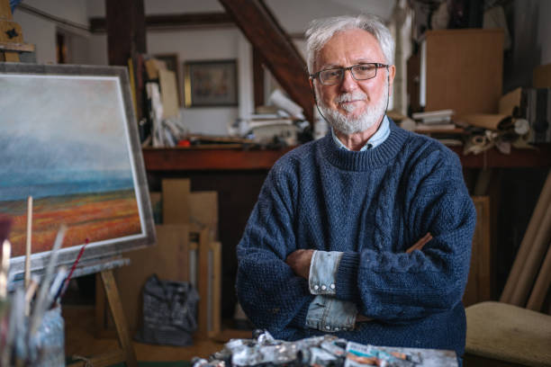Satisfied artist sitting in his art studio