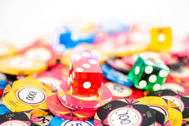 Five white dice on a green cloth background. This theme can be used to illustrate a wide range of financial, gambling, chance and risk themes.