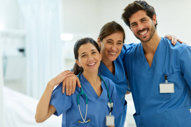 portait of happy team of helthcare workers looking at camera. - happy doctor imagens e fotografias de stock