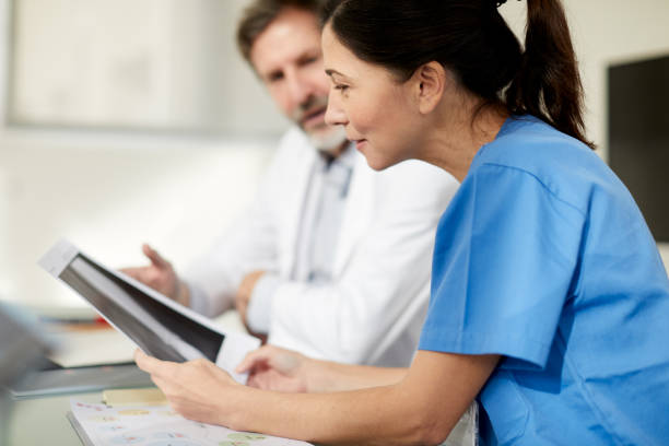 istock A nurse looking at an x-ray image in a briefing meeting. 1220813068