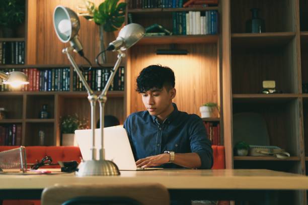 istock Young asian is working on laptop in the library 1220814380