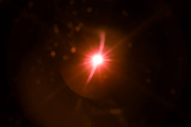 istock abstract lens flare red light over black 1220815877