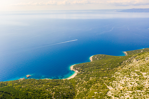 View of an idyllic landscape with the aerial view of the Adriatic Sea coastline with hills and a sandy beach,  Cres Island,  Croatia