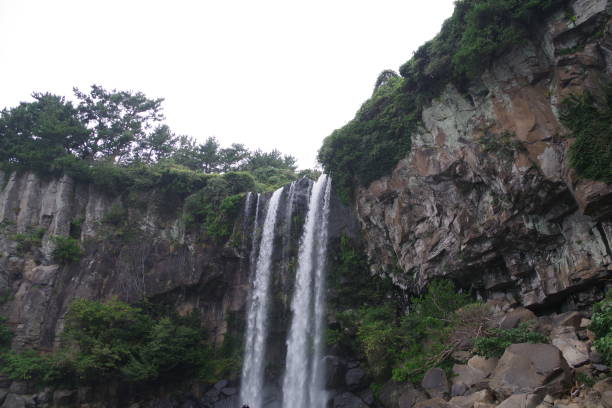 istock Jeongbang water fall in Jeju island 1220817241