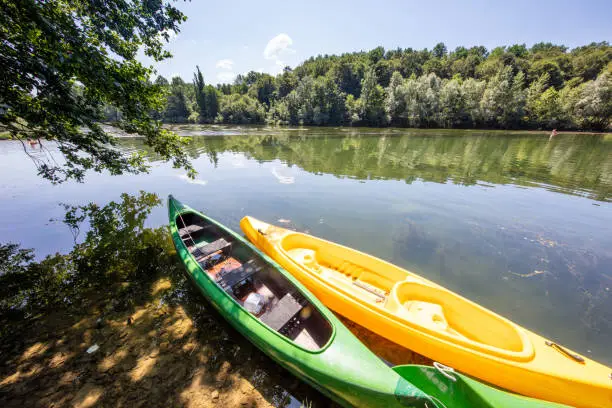 Kayaks moored by Krka River on sunny summer day,  Dolenjska,  Slovenia