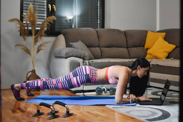 istock Woman working out at home 1220817473