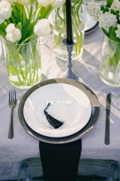 istock Table setting at a luxury wedding and Beautiful flowers on the table. black and white 1220817497