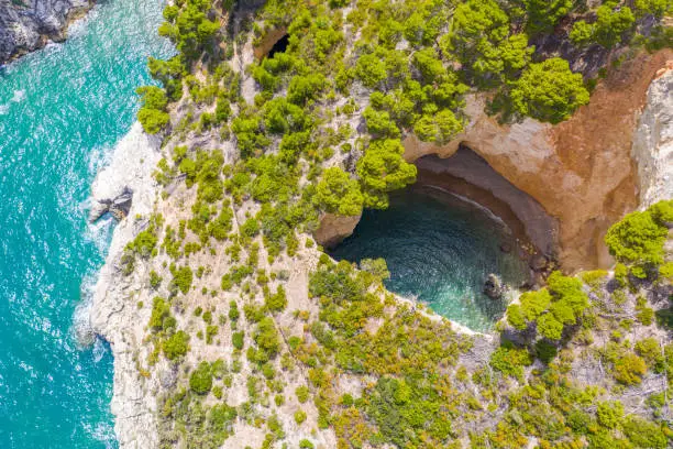 Majestic landscape with drone shot of a cave with water, Gargano National Park, Puglia, Italy