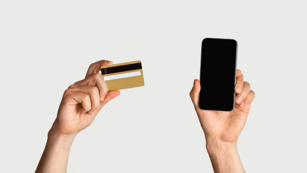 istock Online shopping. Unrecognizable man holdng credit card and smartphone with empty screen, space for design 1220820823