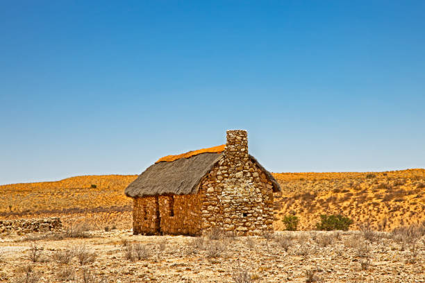 istock Small stone and thatch farmhouse in arid Kalahari 1220821698