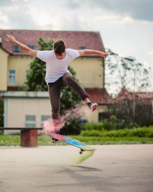 istock Young man doing tricks with skateboard and skateboarding on street 1220821989
