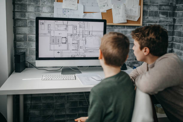 istock Brothers looking an architectural drawings 1220822001