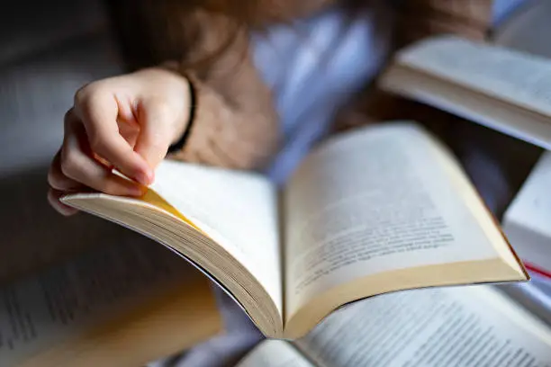 Photo of Reader turning the page of a book.