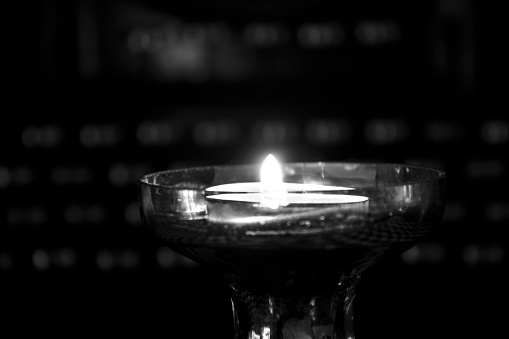 Lighted candle in a dark.