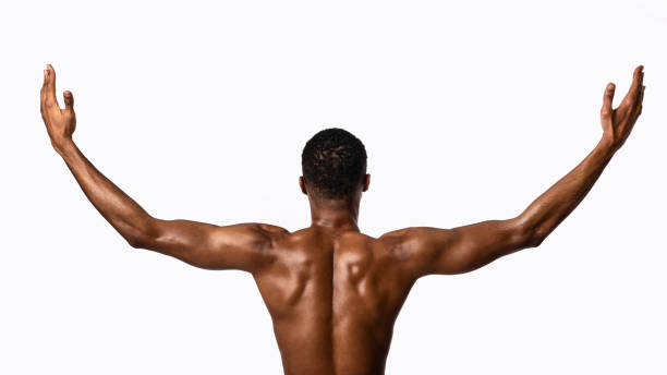 istock Muscular Man Posing Raising Hands Standing On White Background, Rear-View 1220824054