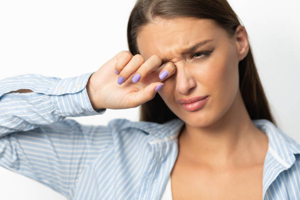 istock Woman Touching Aching Eye Standing On White Background, Studio Shot 1220824082