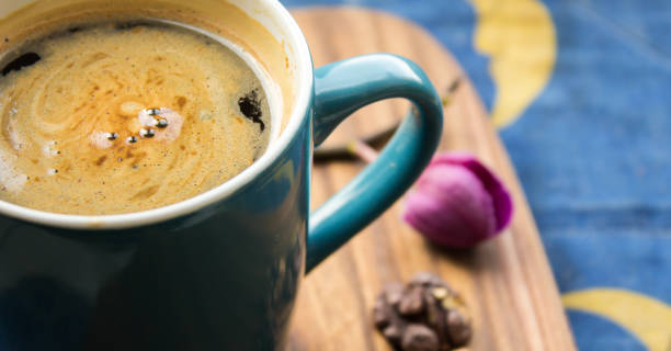 istock A cup of aromatic coffee stands on a wooden table. 1220824189