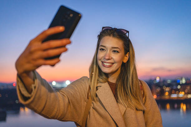 istock Woman is taking selfie at sunset 1220825955