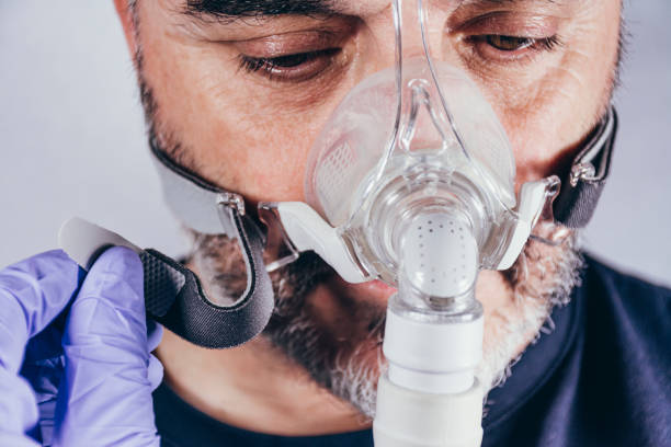 istock Man with respiratory mask for assisted breathing 1220826048